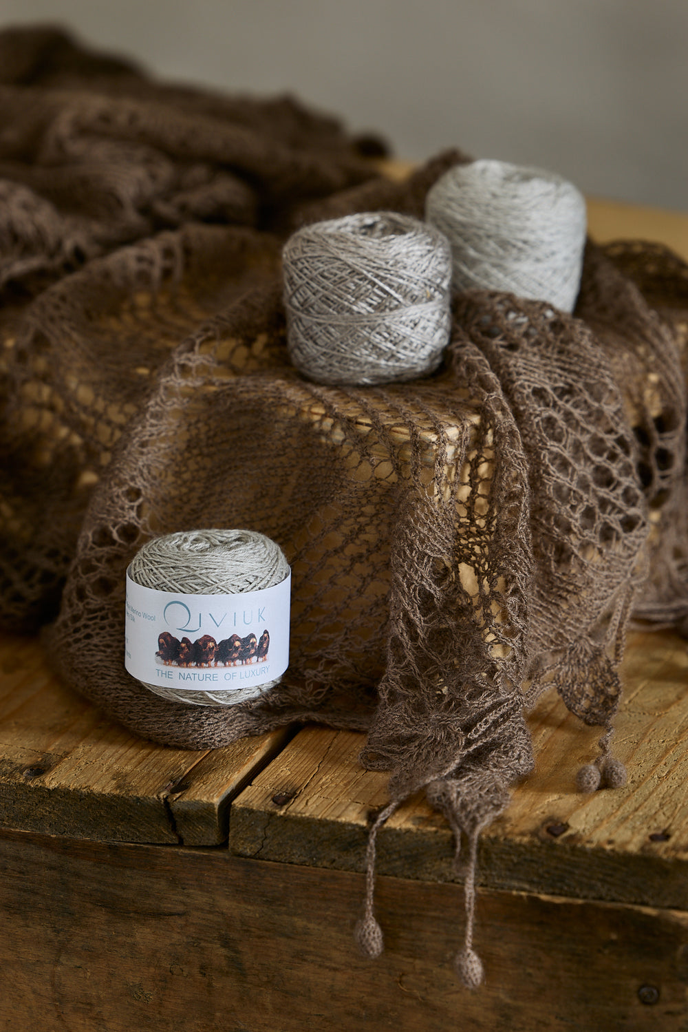 Natural qiviut skeins on a lace shawl