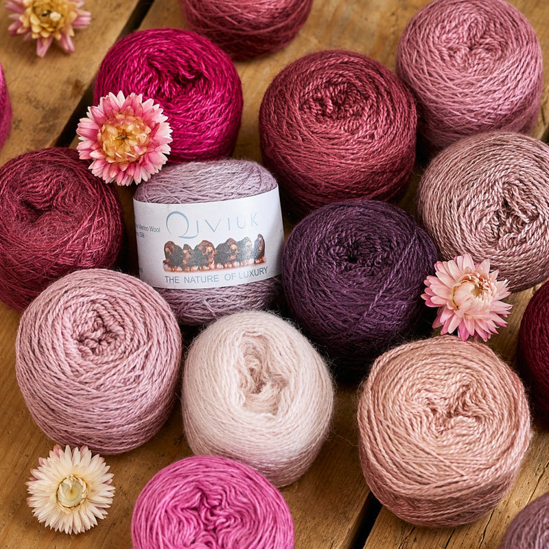 Skeins of qiviut yarn in pink and plum tones